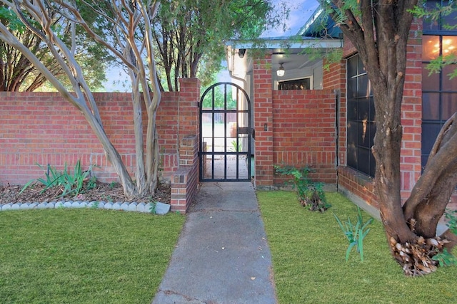 view of gate featuring a lawn