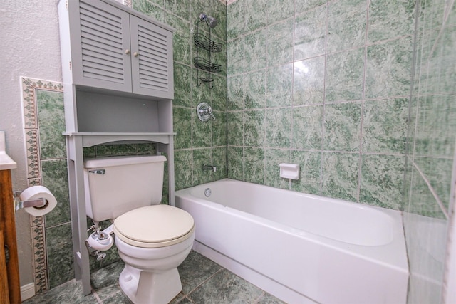 bathroom with shower / bathtub combination, toilet, and tile patterned flooring