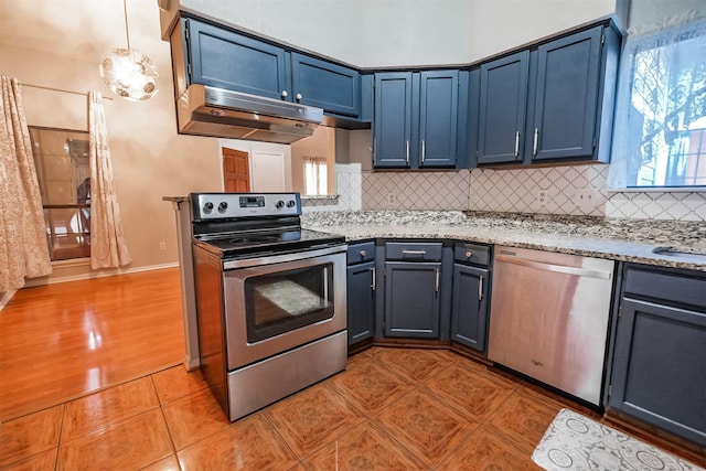 kitchen featuring blue cabinetry, light tile patterned flooring, tasteful backsplash, pendant lighting, and stainless steel appliances