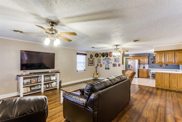 living room with hardwood / wood-style floors, crown molding, and ceiling fan