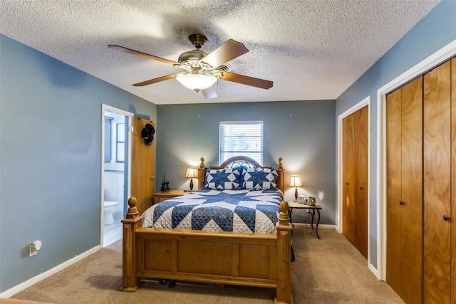 carpeted bedroom featuring ceiling fan, connected bathroom, and a textured ceiling