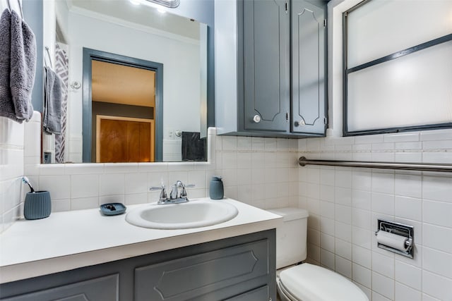 bathroom featuring crown molding, vanity, and toilet