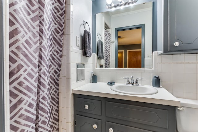 bathroom featuring crown molding, vanity, a shower with curtain, and decorative backsplash