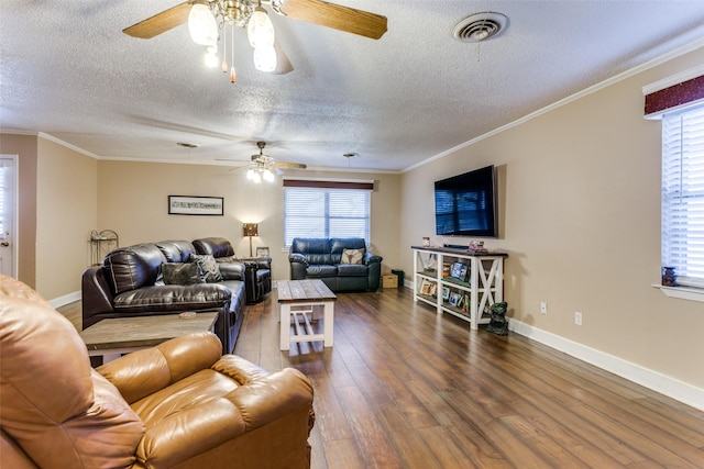 living room with dark hardwood / wood-style flooring, ceiling fan, crown molding, and a textured ceiling