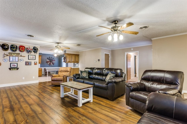 living room with ornamental molding, hardwood / wood-style floors, a textured ceiling, and ceiling fan