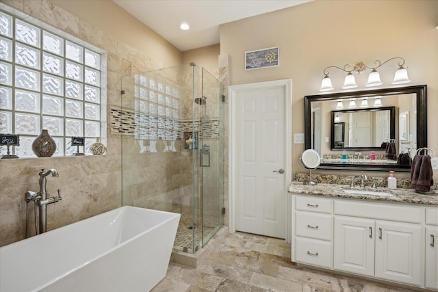 bathroom featuring vanity and separate shower and tub