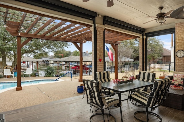 view of patio featuring a community pool, ceiling fan, and a pergola