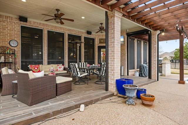 view of patio / terrace with an outdoor living space, a pergola, and ceiling fan