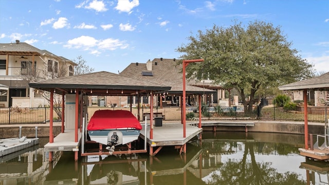 dock area featuring a gazebo and a water view