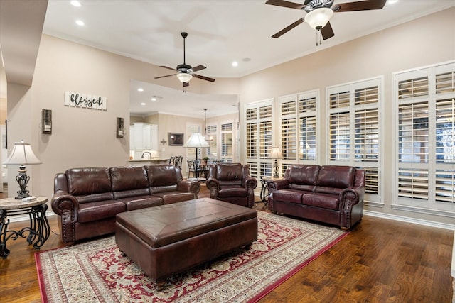 living room featuring crown molding, dark wood-type flooring, and ceiling fan