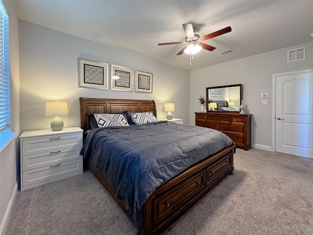 bedroom with baseboards, ceiling fan, visible vents, and light colored carpet