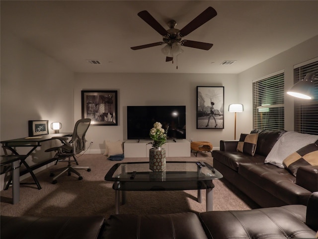 carpeted living area with a ceiling fan, visible vents, and baseboards