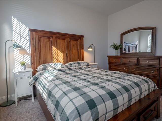 bedroom featuring light colored carpet