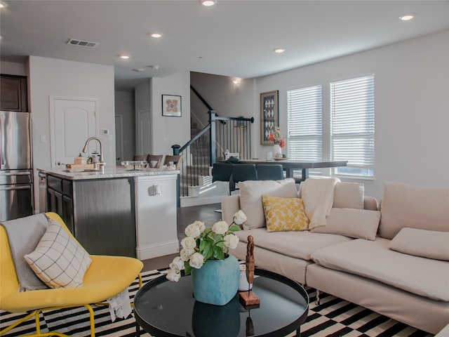 living room featuring visible vents, stairway, and recessed lighting