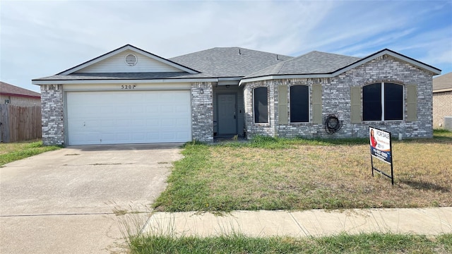 view of front of property featuring a garage and a front lawn