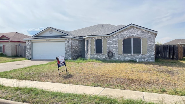 view of front of house with a garage and a front lawn