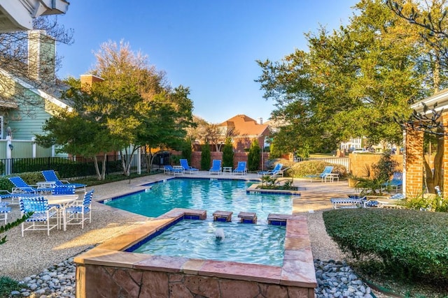 view of pool with a patio area and a hot tub