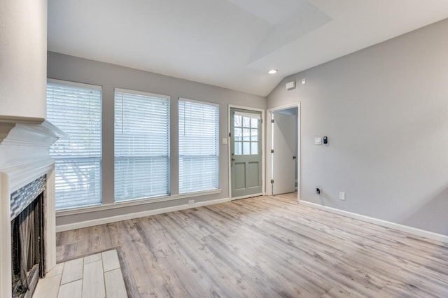 interior space featuring vaulted ceiling and light hardwood / wood-style floors