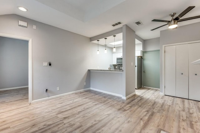 unfurnished living room with lofted ceiling, ceiling fan, and light hardwood / wood-style floors