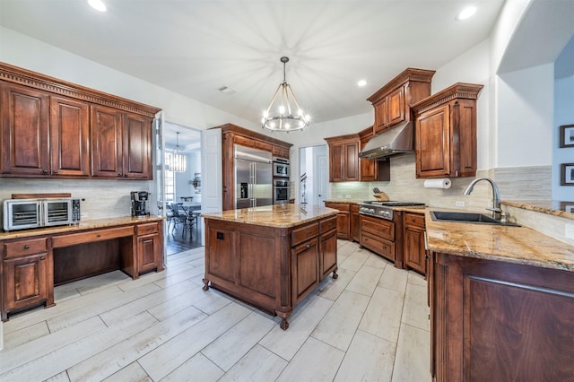 720 Amistad Dr, Prosper, TX 75078 - kitchen with appliances with stainless steel finishes, under cabinet range hood, a sink, a chandelier, and light stone counters