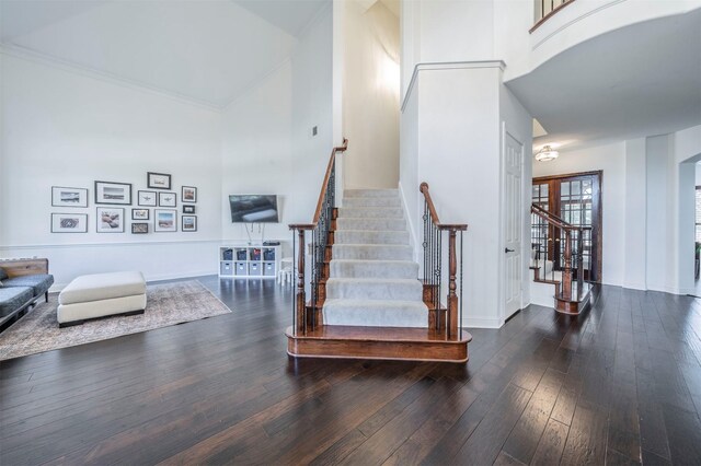 720 Amistad Dr, Prosper, TX 75078 - stairs featuring a towering ceiling, wood-type flooring, and baseboards