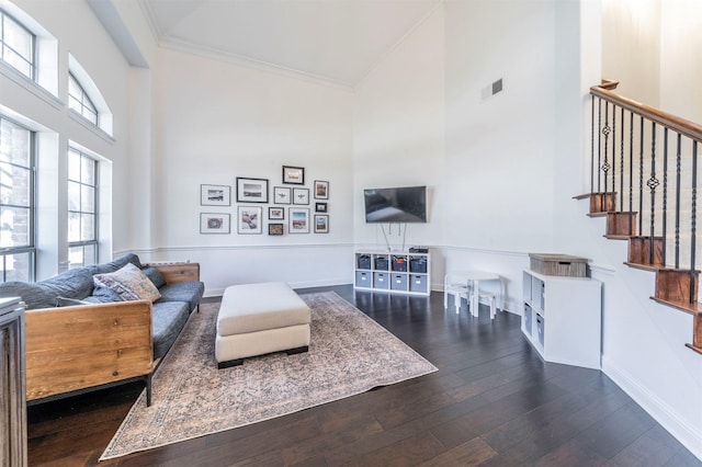 720 Amistad Dr, Prosper, TX 75078 - living area featuring a towering ceiling, dark wood-style flooring, ornamental molding, baseboards, and stairs