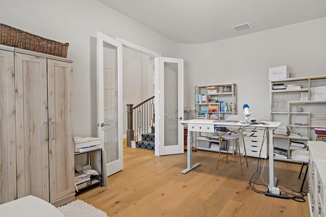 office area with light hardwood / wood-style flooring and french doors