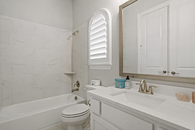 full bathroom featuring vanity, tiled shower / bath combo, and toilet