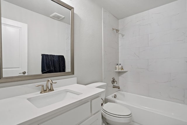 full bathroom featuring vanity, toilet, and tiled shower / bath