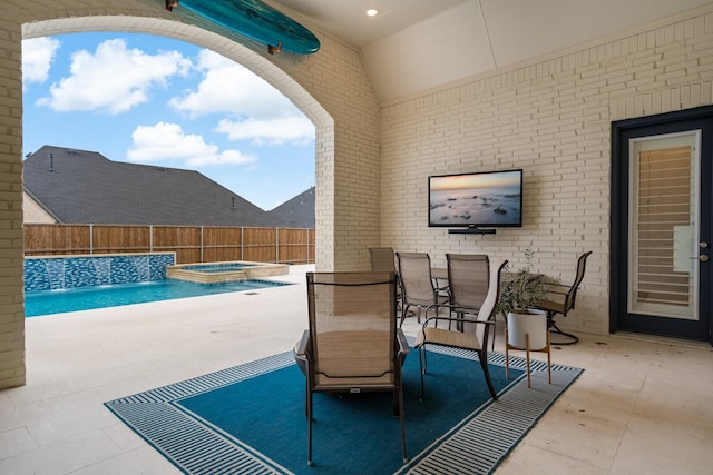 view of patio / terrace featuring a swimming pool with hot tub and pool water feature