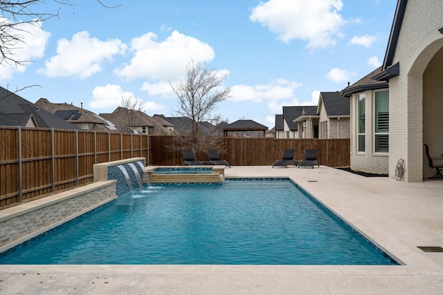 view of swimming pool featuring an in ground hot tub, pool water feature, and a patio