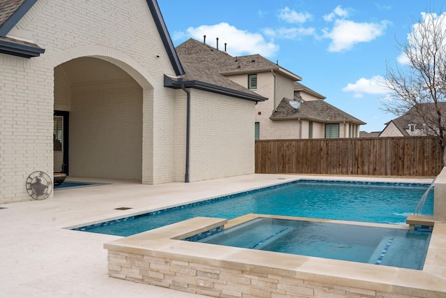 view of swimming pool with an in ground hot tub, pool water feature, and a patio