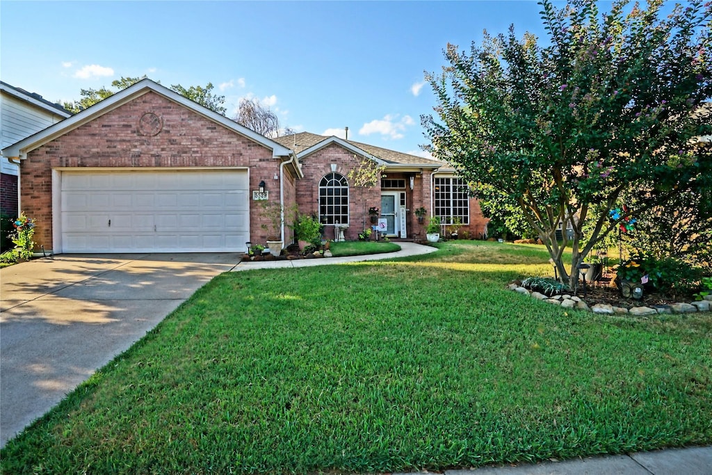 view of front of house with a garage and a front yard