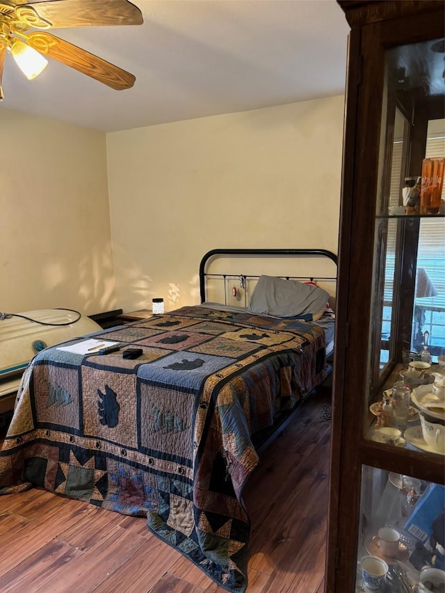 bedroom with hardwood / wood-style floors and ceiling fan