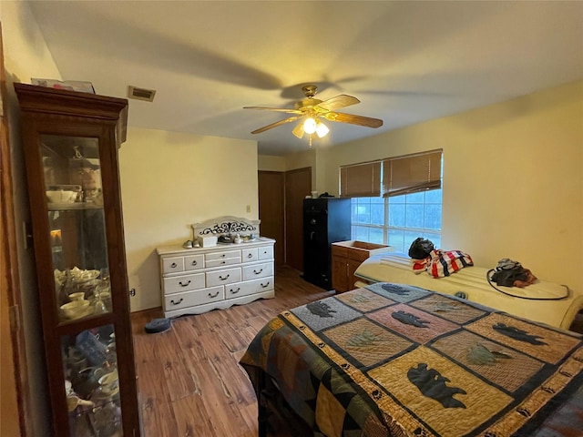 bedroom featuring dark hardwood / wood-style flooring and ceiling fan