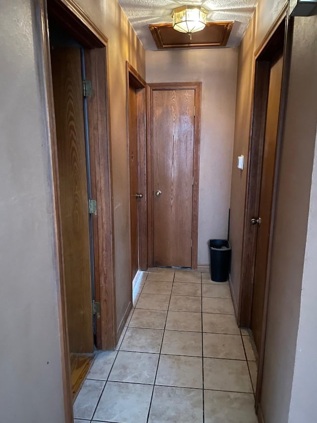 corridor featuring light tile patterned floors