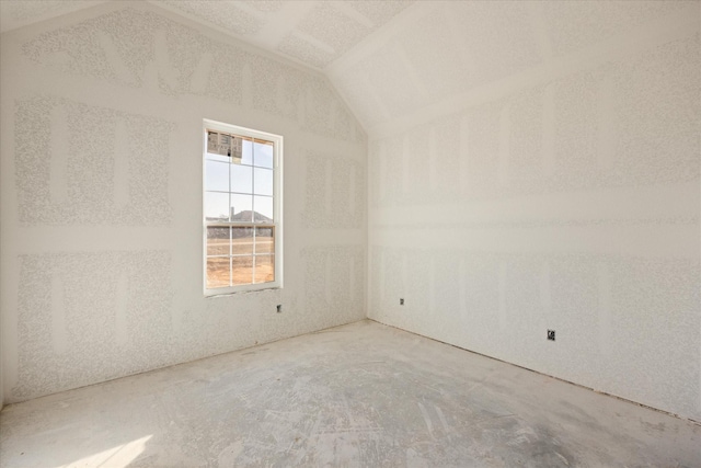 spare room featuring lofted ceiling