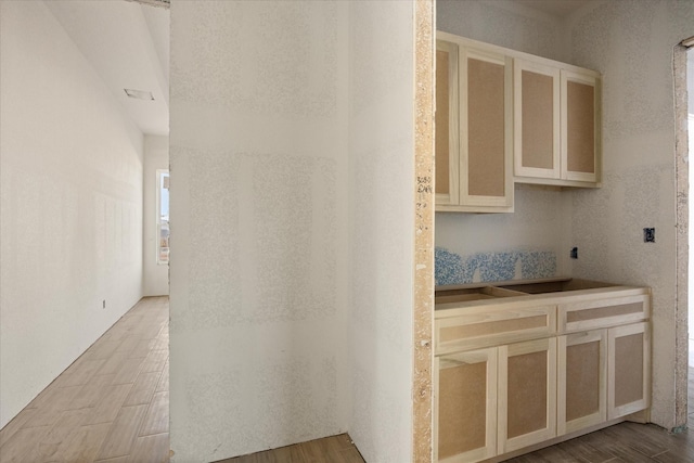 interior space featuring glass insert cabinets and wood finished floors