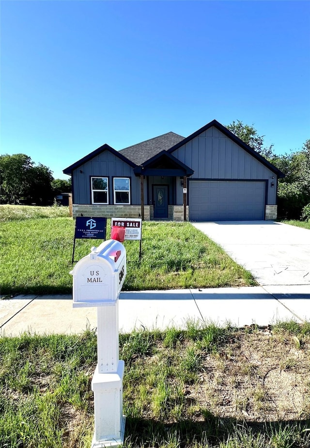 5065 Willie St, Fort Worth, TX 76105 - view of front of house featuring driveway, a garage, board and batten siding, and roof with shingles