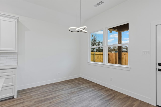 5065 Willie St, Fort Worth, TX 76105 - unfurnished dining area with a chandelier, baseboards, and light wood finished floors