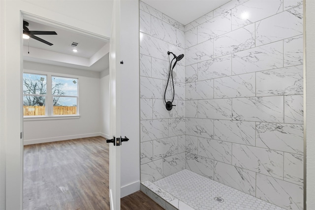 5065 Willie St, Fort Worth, TX 76105 - bathroom with tiled shower, wood finished floors, ceiling fan, and baseboards