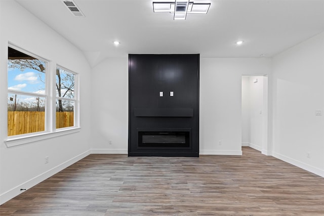 5065 Willie St, Fort Worth, TX 76105 - unfurnished living room featuring wood finished floors, recessed lighting, baseboards, a large fireplace, and vaulted ceiling