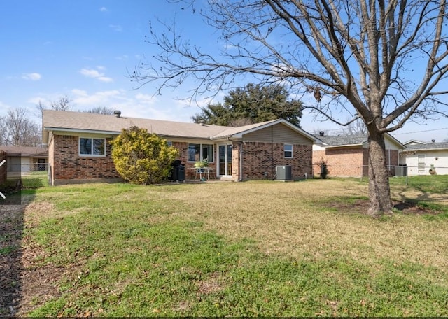 rear view of property featuring cooling unit and a lawn