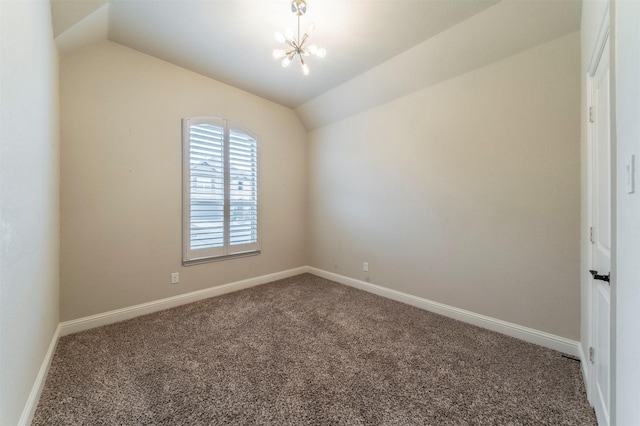 carpeted spare room with a notable chandelier and vaulted ceiling