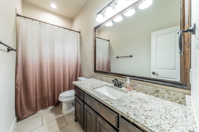 bathroom with tile patterned flooring, vanity, and toilet