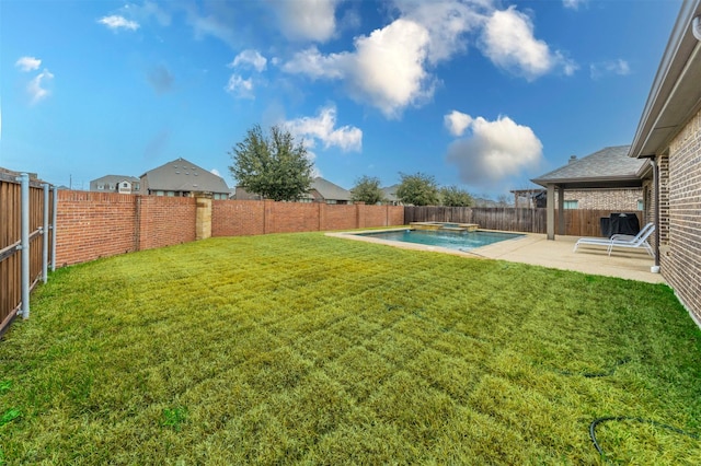 view of yard with a fenced in pool and a patio area