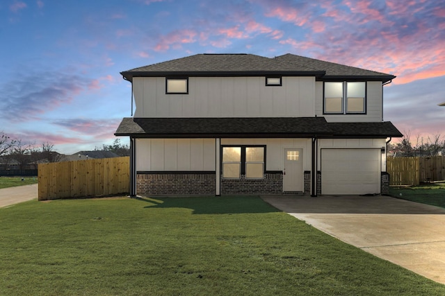 view of front facade featuring a yard and a garage