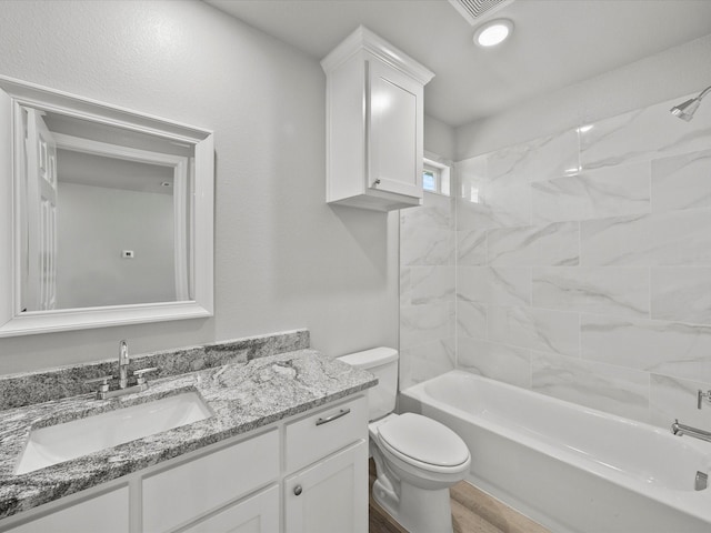 full bathroom featuring vanity, wood-type flooring, toilet, and tiled shower / bath