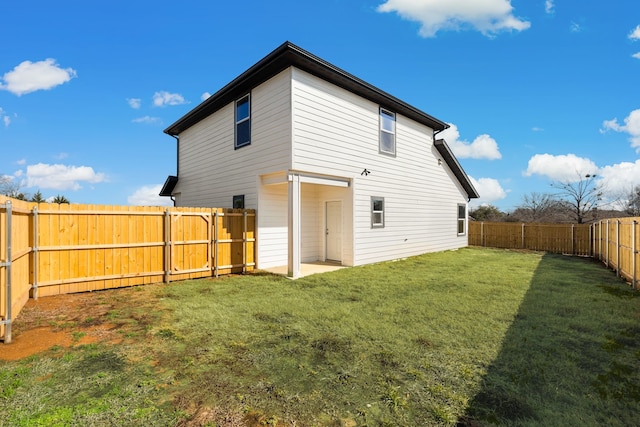 back of house featuring a lawn