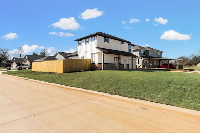 view of side of home featuring a yard and a carport